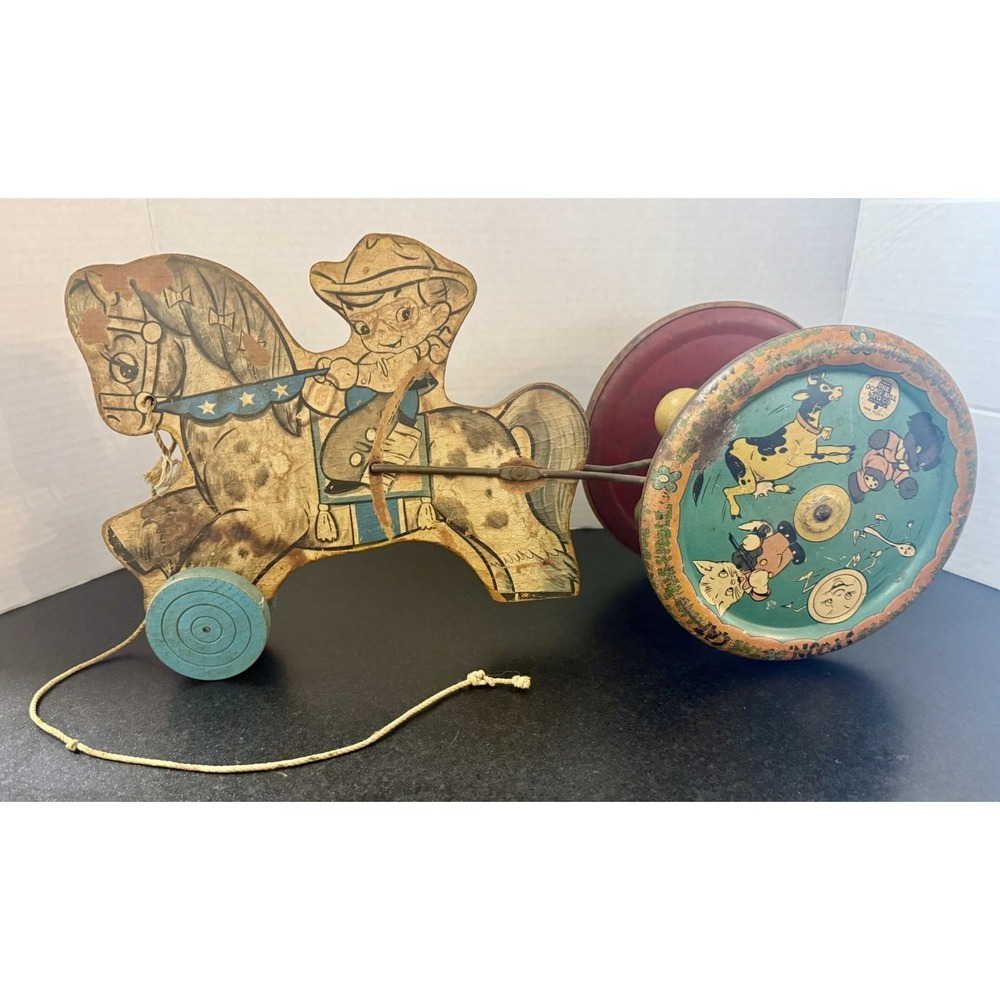 This is a vintage 1940s wooden lithographed metal pull toy By Gong Bell Mfg